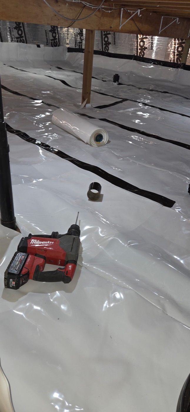 A sealed vapor barrier laid across a crawlspace for radon control