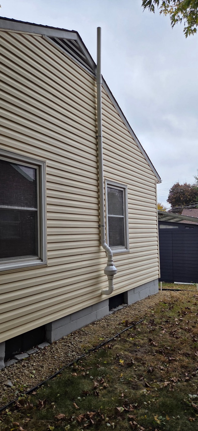 A finished radon mitigation system installed on a Twin Cities home